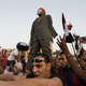Egyptian protesters beat a dummy of Mohamed Morsi in Cairo's Tahrir Square. (Gianluigi Guercia/AFP/Getty Images)